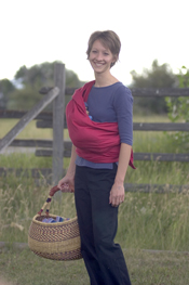 LeoRougeHipCradle Cradle carry with a Storchenwiege Wrap holding baby's upper body (head to butt) in more of a straight line so the chin isn't tucked.