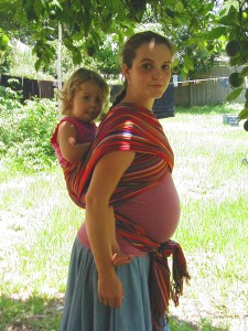 pregnant bwcc Two year old in a BWCC tied under pregnant bump.