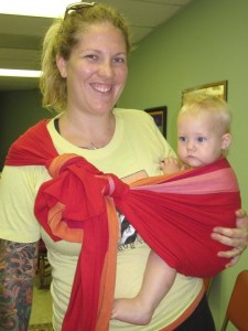 Dana wearing 1 year old Jocelyn in a rebozo hip carry