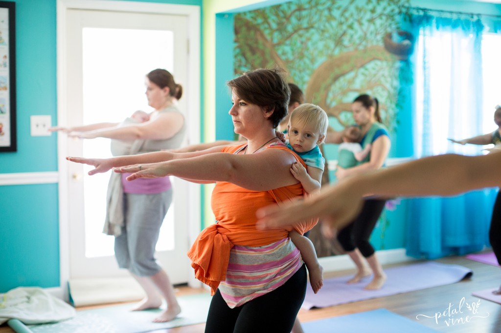 Wrapped up babies and toddlers in babywearing yoga class.