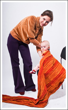 Rucksack Carry Instructions Step 1 - put the center of the wrap at baby's back